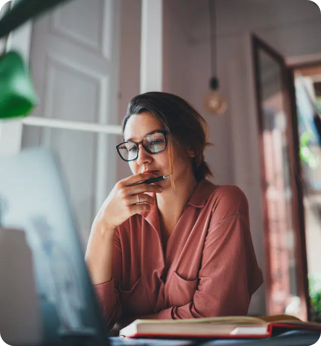 Business woman thinking looking at computer