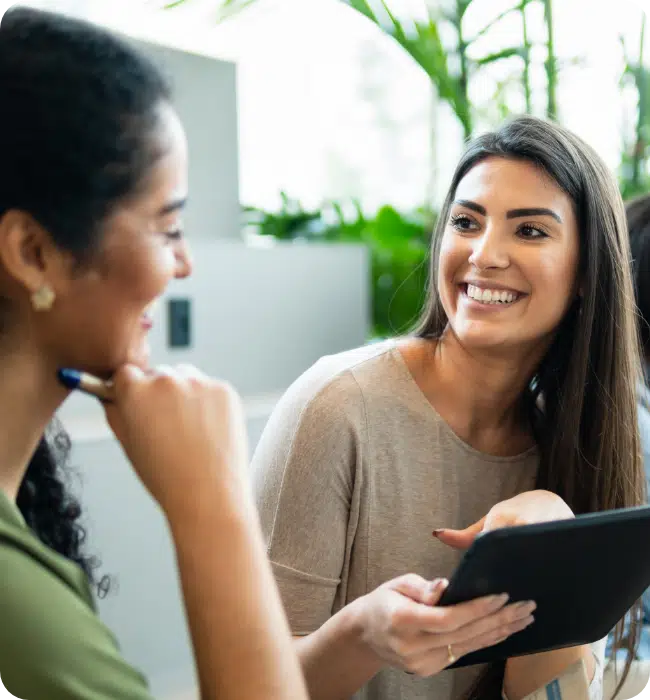 women talking with an iPad