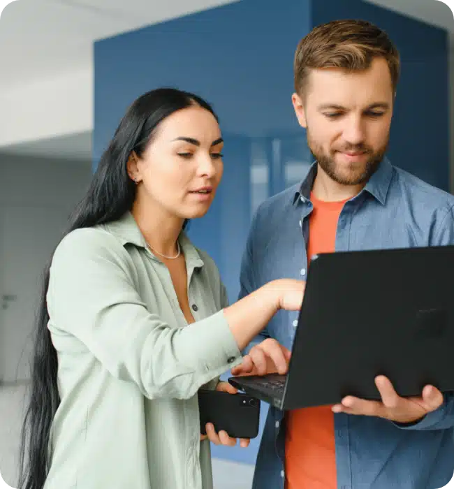 man and women looking at laptop