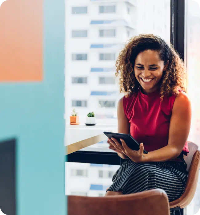 Business woman in office - sat with tablet