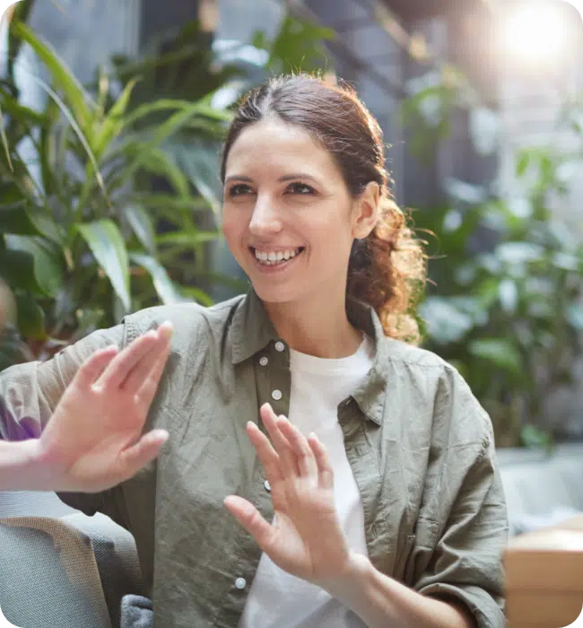 Woman in a casual business meeting - sat down presenting